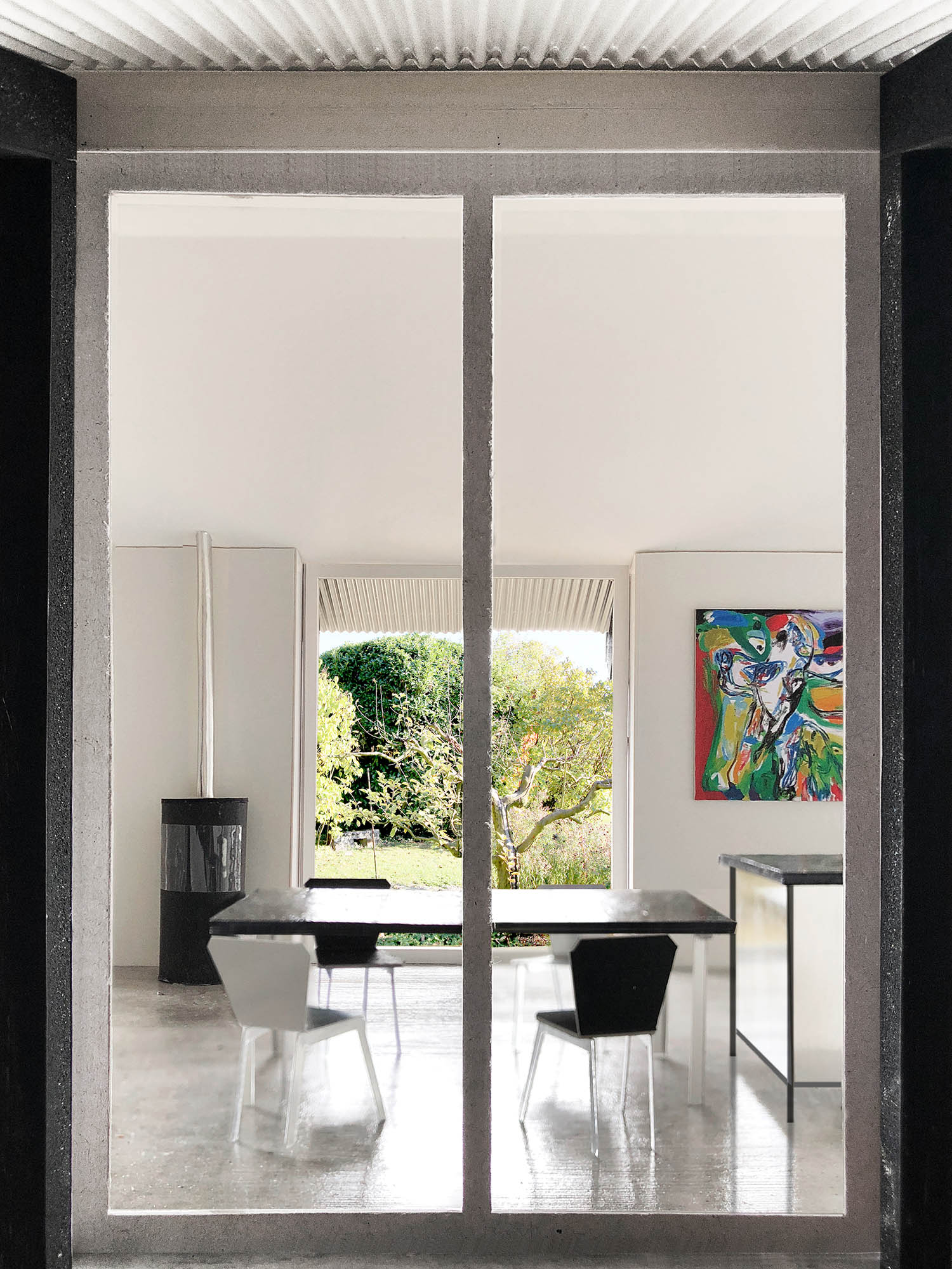 The Permanent Weekend House is a thin and long construction, extending an old chalet through its garden