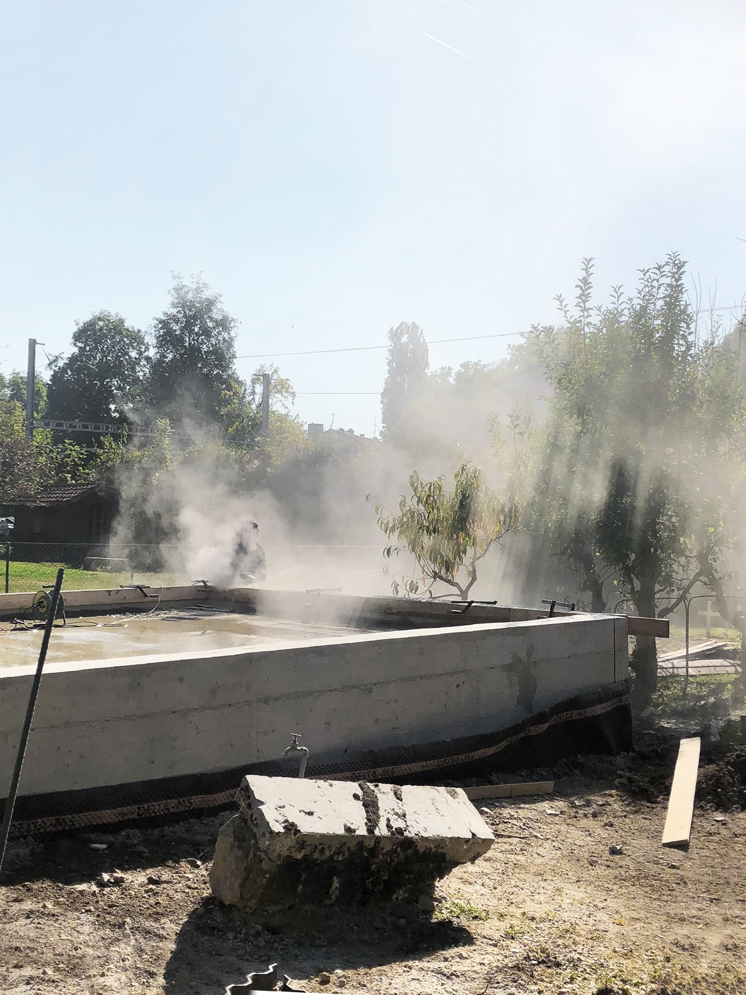 The Permanent Weekend House is a thin and long construction, extending an old chalet through its garden