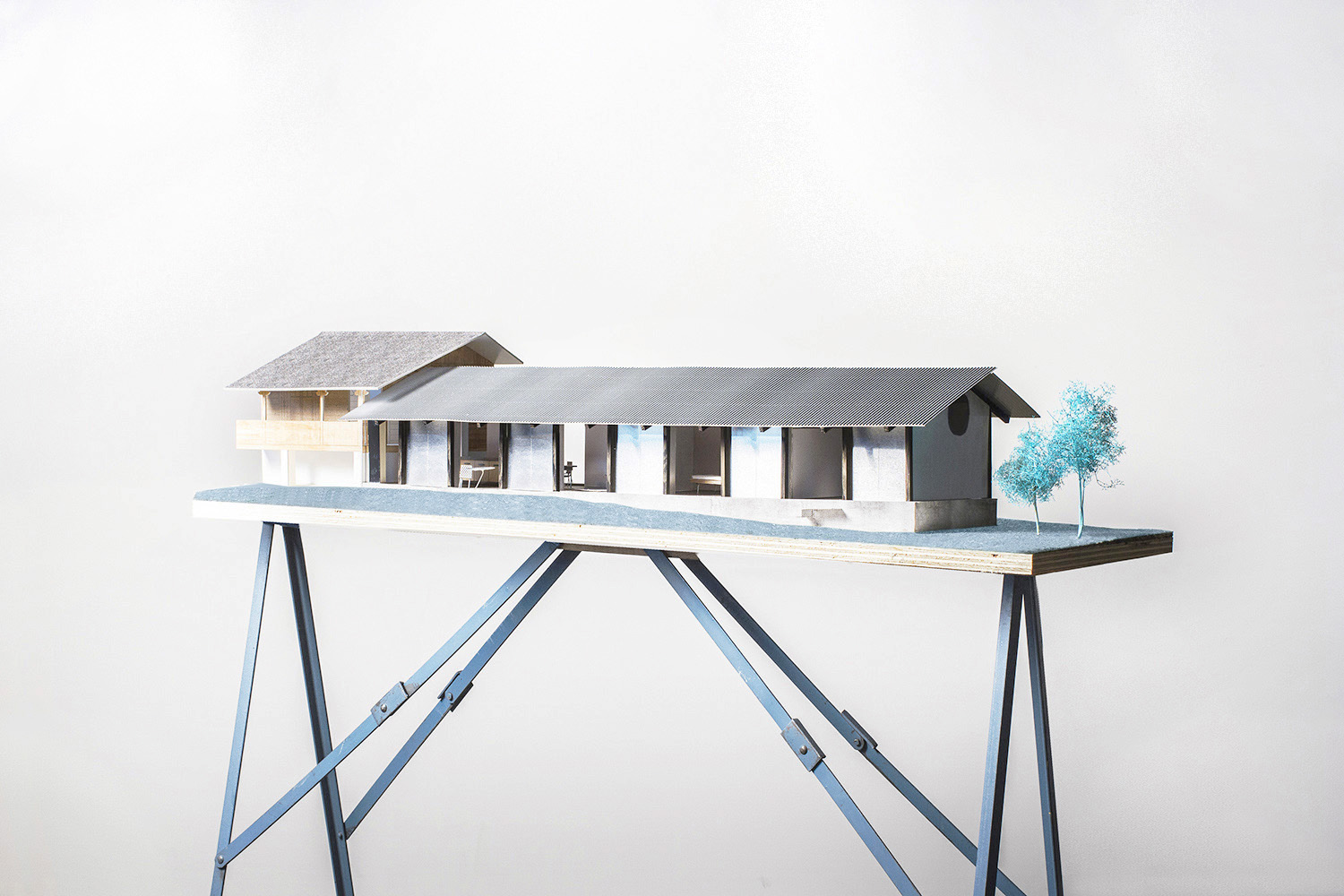 The Permanent Weekend House is a thin and long construction, extending an old chalet through its garden